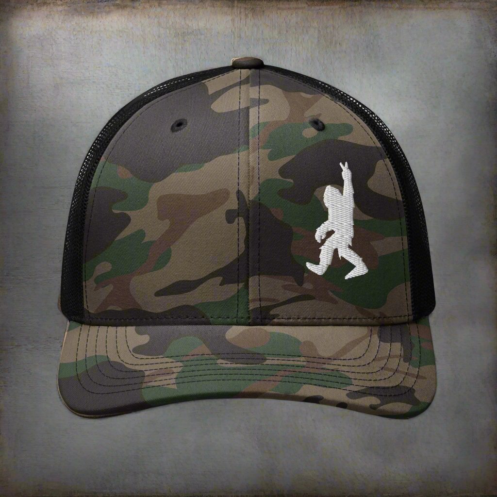  - Bigfoot Peace Sign | Camouflage Trucker Hat | Meshback Ball Cap from Crypto Zoo Tees