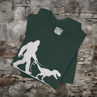 T-Shirt - Bigfoot Walking Baby T-Rex Dinosaur Shirt | Bella + Canvas Unisex T-shirt from Crypto Zoo Tees