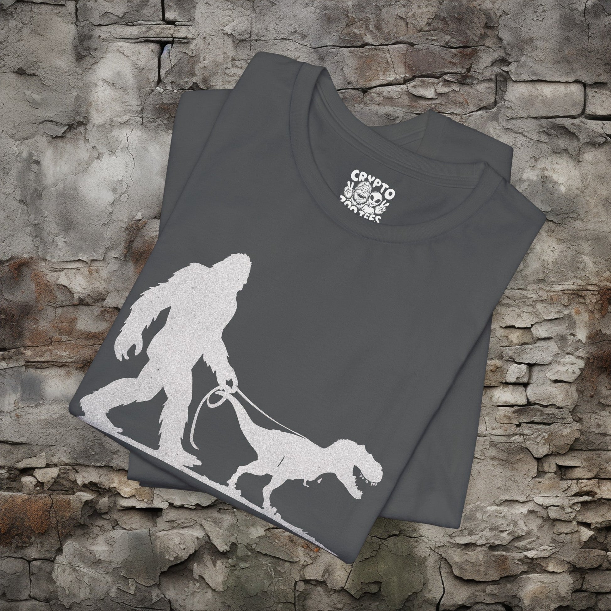 T-Shirt - Bigfoot Walking Baby T-Rex Dinosaur Shirt | Bella + Canvas Unisex T-shirt from Crypto Zoo Tees